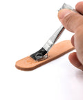 Applying Go To Clear Shoe Glue For Leather Vinyl Rubber Fabric 4 Oz Professional Strength Quick Dry Waterproof Bond with brush to leather patch.