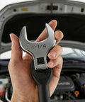 Heavy Duty 1/2 Inch Drive Jumbo Crowfoot Wrench 1 1/4 Inch SAE Open End Wrench held in hand above car engine.