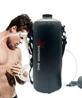 Foldable 12L Solar Heated Camping Shower Kit With Removable Hose And Showerhead in use outdoors by a man