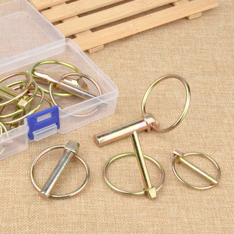 Eight Pack Five Sixteenth Inch Lynch Pins With Rings Heavy Duty Kit for tractors trailers and mowers displayed on fabric surface.