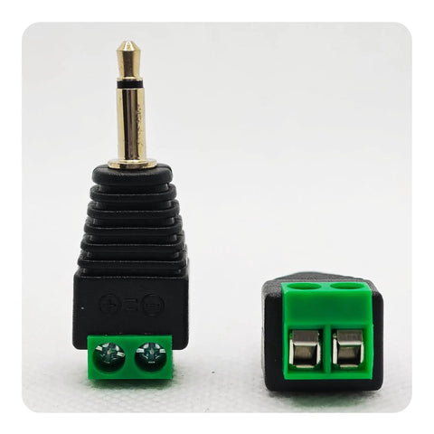 Close-up of a 3.5 mm stereo audio jack adapter, one eighth inch male to two pin female screw terminal, for hassle free speaker wire hookups.