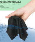 Microfiber cleaning cloth, black, 7 x 6 in, held in hand under running water
