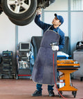 Top Notch Cowhide Welding Apron Replacement For Heat Resistant Protection That Fits Snugly Allows Movers To Work Freely On Any Job Site Without Worry worn by a male mechanic.
