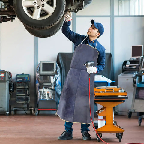Top Notch Cowhide Welding Apron Replacement For Heat Resistant Protection That Fits Snugly Allows Movers To Work Freely On Any Job Site Without Worry worn by a male mechanic.