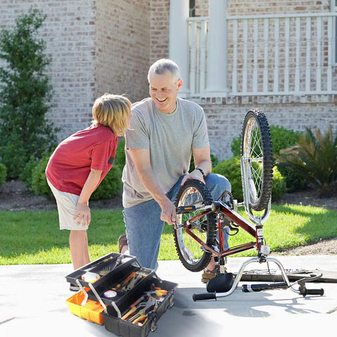 Man and child fixing bike using 16.5 Inch Three Layer Folding Tool Box Organizer With Portable Handle outdoors