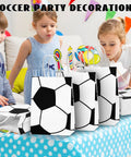 Children enjoying a party with 12 Pack Soccer Themed Party Favor Bags With Handles, perfect for treats and candy, on a colorful table.