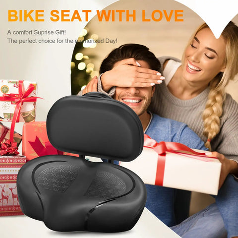 Ultra Wide Bike Seat Cushion With Extra Padding And Back Rest For Men And Women, Oversized Comfortable Cushy Saddle For Peloton, Exercise, Electric, Mountain, Spin And Cruiser Bikes. Black padded bike seat with back rest shown on gift-themed background.