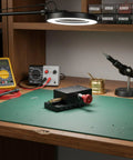 Top Notch Precision Dovetail Linear Stage With Dovetail Guide And Manual Rack And Pinion Travel For Rock Solid Fine Positioning Optical Alignment And Small Fixture Adjustments In Scientific Labs And Research. black metal dovetail linear stage with red handwheel on workbench