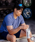 Man in blue shirt using No Sweat Leakproof 20 Oz Hot Pink Shaker Bottle With Secure Hinge Lid And Fast Flow Spout.