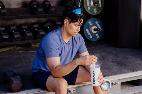 Man in blue shirt using No Sweat Leakproof 20 Oz Hot Pink Shaker Bottle With Secure Hinge Lid And Fast Flow Spout.