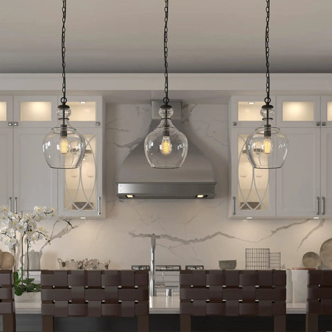 11 Inch Mid Century Modern Pendant Light With Clear Glass Dome Shade And 6 Foot Adjustable Cord For Kitchen Islands, Dining Rooms Or Game Rooms In Blackened Bronze Super Sleek illuminating a kitchen.