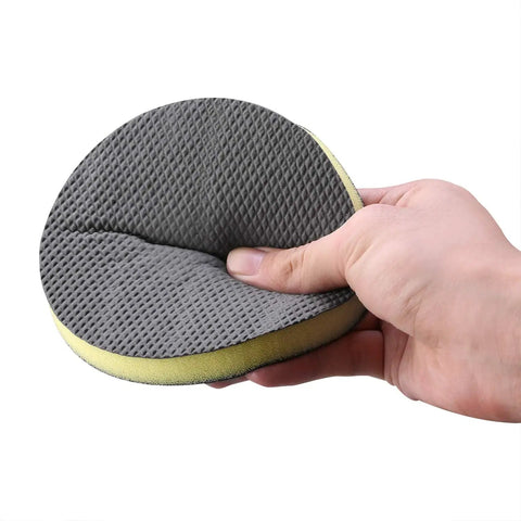 Hand holding 6 Inch Fine Grade Clay Pad For DA Polisher with Velcro backing, clay bar pad wipe foam pad for car detailing.