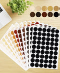 648 Piece Screw Hole Cover Sticker Set In 12 Colors, Adhesive PVC Caps For Wood Screws displayed on a desk.