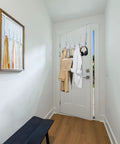 Over The Door Hook Rack With 5 Tri Hooks For Coats And Towels, Space Saver Door Hanger with White Finish, shown in use on entry door
