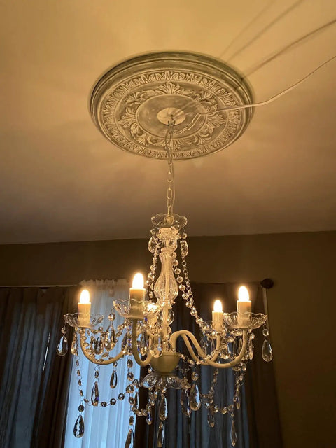 Plug-In Five Light Crystal Chandelier Swag Hanging Fixture With White Metal Frame And Clear Glass Stems And Acrylic Crystals Ideal For Nurseries Bedrooms Bathrooms Closets Hallways And Events hanging in room with lights illuminated