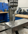 Top Shelf 7 Piece Center Drill Bit Set Crafted From Heavy Duty M2 High Speed Steel With A Sharp 60 Degree Countersink Design Ideal For Lathe Work And Shop Metalworking Tasks Featuring A Dead Reliable Range Of Exact Hole Sizes Included, drilling into metal block.