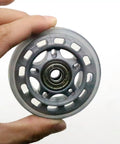 Hand holding 64mm inline skate wheel with ABEC7 bearing and 82A polyurethane clear replacement wheels for skates office chairs and luggage ride smooth and durable 4 pack