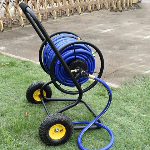 Heavy Duty Garden Hose Reel Cart Rolling On Smooth Casters With Cushioned Handles, No Drama Metal Water Pipe Storage Rack, Outdoor Irrigation Roller Turned By A Quick Crank, Legit Hose Keeper For Long Garden Lines with blue hose on grass.