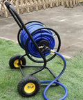 Heavy Duty Garden Hose Reel Cart With Oversized Rolling Wheels And Comfy Foam Grip Handle For Smooth Operation And Hassle Free Outdoor Irrigation Organization on grass.