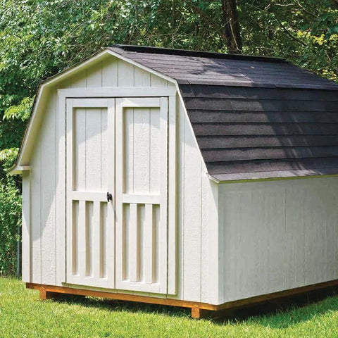 Outdoor wooden shed with dark roof in a backyard setting, surrounded by trees and grass.