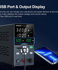 Variable 30V 10A Bench Power Supply with USB Fast Charging Port and Output Current Display next to a smartphone charging