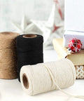 Three Rolls Of 984 Ft Twine String 2mm Natural Jute And White Cotton Rope For Crafts DIY Projects Gardening Gift Wrapping And Decoration Packing Bulk displayed with gift boxes.