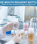 Person handling a Wide Mouth Plastic Bottle Set With Airtight Lids, 24 Pcs, 1 Oz 2 Oz 4 Oz Graduated in a lab environment.