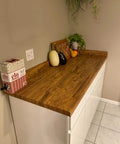 Wood Grain Peel And Stick Wallpaper For Countertops And Cabinets Waterproof Easy To Clean Self Adhesive Removable Vinyl Roll Rustic Brown Yellow 17.7 Inch Wide By 78.7 Inch Long DIY Friendly No Mess Kitchen Remodel covering a kitchen countertop with vegetables and plants.