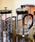 Four French press coffee makers, including a Natural Grain Glass And Bamboo 1 Liter French Press Coffee And Tea Maker With Removable Glass Carafe