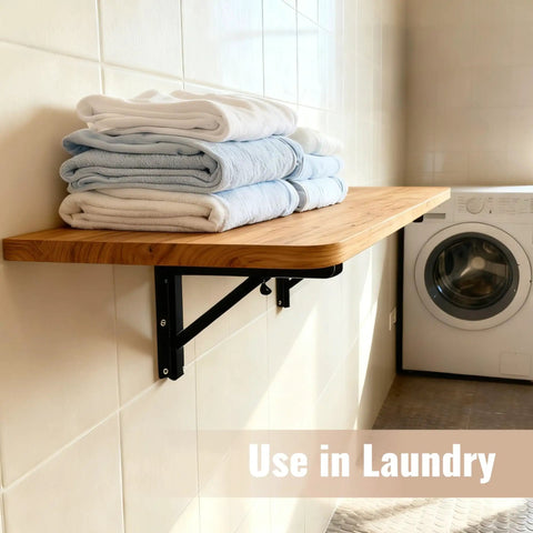 Wall Mounted Folding Table For Garage And Laundry Room Use, Handy Home Wall Desk And Folding Workbench, Space Saver That Handles Up To 100 Lbs, Solid Wall Mount Only, 15.7 By 31.5 Inches, Easy Fold Down Surface with towels in a laundry room.