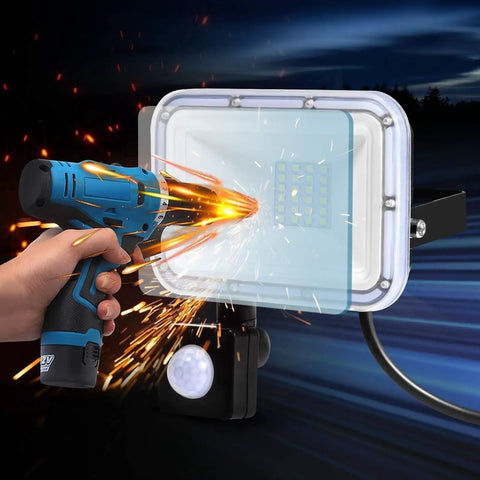 JUDYSSY Led Pir Floodlights 20W with motion sensor, showcasing heat dissipation design and operational use with power tool.
