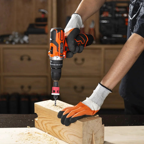 Side view of orange and black cordless drill with pink depth-stop countersink bit drilling into a wooden block.