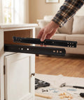 Heavy Duty Soft Close Bottom Mount Drawer Slides For Cabinets being installed in a white cabinet by a DIY enthusiast.