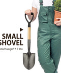 Person holding 28-inch round small shovel with wooden D handle for digging and planting in garden, showing carbon steel rust-resistant blade.