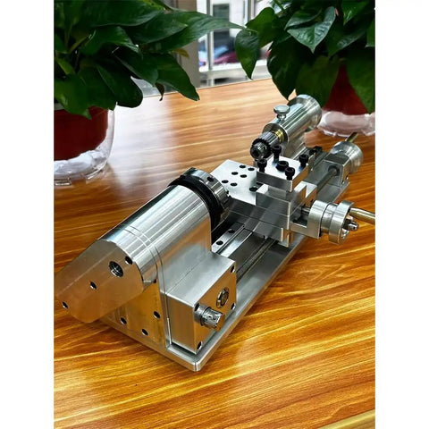 Compact Mini Metal Lathe For Benchtop Use With 3 Jaw Chuck And Tailstock, aluminum construction, precision design on wooden table.