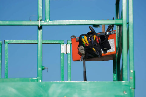 Beefed Up Tool Organizer Bin For Scaffolding And Aerial Work Platforms with tools inside attached to aerial lift railing