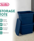 No Sweat 18 Gallon Plastic Storage Totes With Secure Snap Lids 32 Pack stacked navy blue bins for organizing clothes and linens.