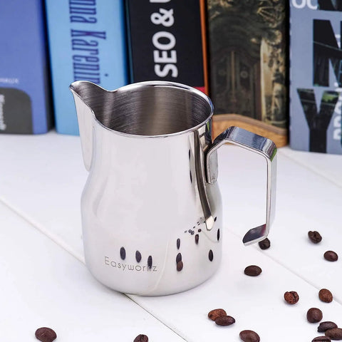Stainless Steel 15 Ounce Espresso Steaming Pitcher For Milk Frothing And Latte Art With Dripless Spout Pro Grade Durable Anti Rust 304 Food Grade Milk Jug For Cappuccino on white table with coffee beans