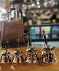 Hand Hammered Copper Turkish Greek Arabic Armenian Coffee Pot Large 18 Fl Oz Stovetop Cezve Jazzve Ibrik Briki in a cafe.