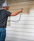 Person using Airless Spray Gun SG3 Pro Kit For Heavy Duty Coatings 3600 PSI Four Finger Trigger With Safety Lock on siding