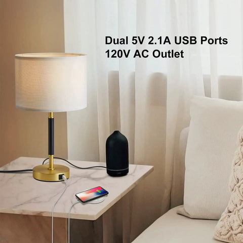 Gold finish lamp with white linen shade, dual USB ports, AC outlet on a table. Touch Control Table Lamp Set Of 2 Gold Finish Lamps With Dual USB Ports And AC Outlet, 3 Way Dimmable Modern Nightstand Light For Bedroom And Living Room, White Linen Shade, LED Bulbs Included visible.