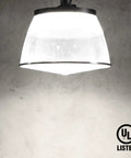 UFO LED High Bay Light With Reflector Beast Brightness 21700 Lumen 150W illuminated against a concrete wall, UL Listed