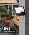 JUDYSSY Solar Flood Lights Led Flood Light installed on a wall, showcasing IP65 waterproof rating in outdoor setting.