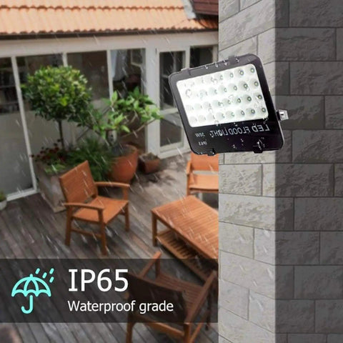 JUDYSSY Solar Flood Lights Led Flood Light installed on a wall, showcasing IP65 waterproof rating in outdoor setting.