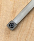 Carbide woodturning tool bit on metal shank with square cutter, gray finish