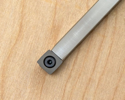 Carbide woodturning tool bit on metal shank with square cutter, gray finish