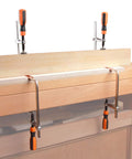 Track F Clamp For 3/8 x 3/4 Double Cut T-Track, 6 Inch Opening, 2 3/8 Inch Throat installed on a woodworking bench