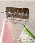 Heavy Duty Wall Mounted Adhesive Free Suction Hooks With Rock Solid Air Pressure Grip Hang Clothes Hats Bags And Keys Rust Resistant Metal Wire Finish No Wall Damage sleek metallic hooks holding a pink towel and a green pot holder on a tiled wall.