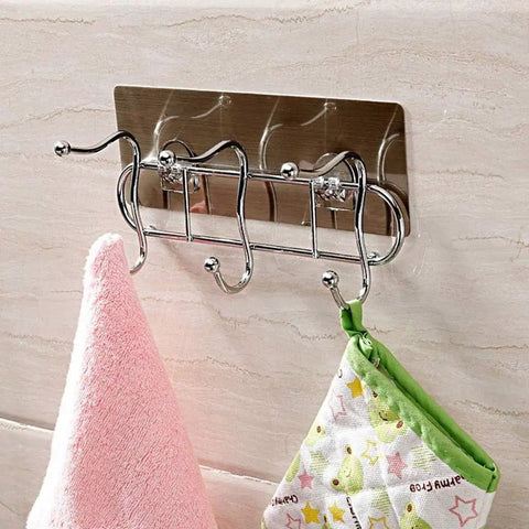 Heavy Duty Wall Mounted Adhesive Free Suction Hooks With Rock Solid Air Pressure Grip Hang Clothes Hats Bags And Keys Rust Resistant Metal Wire Finish No Wall Damage sleek metallic hooks holding a pink towel and a green pot holder on a tiled wall.