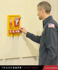 Person using Lockout Tagout Station Kit With 26 LOTO Devices And 20 Do Not Operate Tags Padlock Hasps Wall Mount Board OSHA Compliant